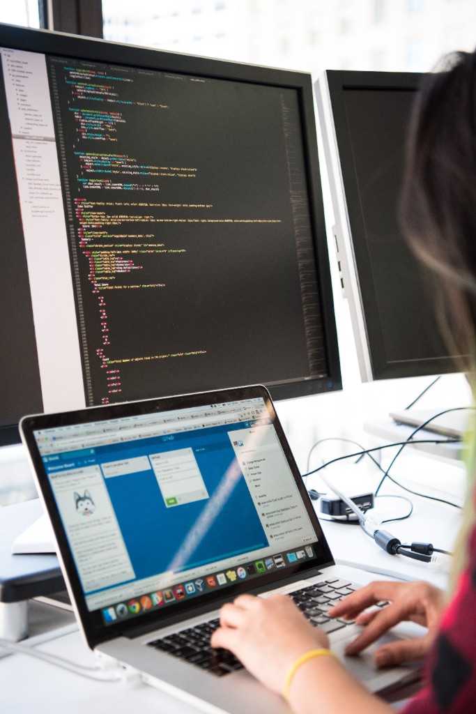 Writing code at a laptop